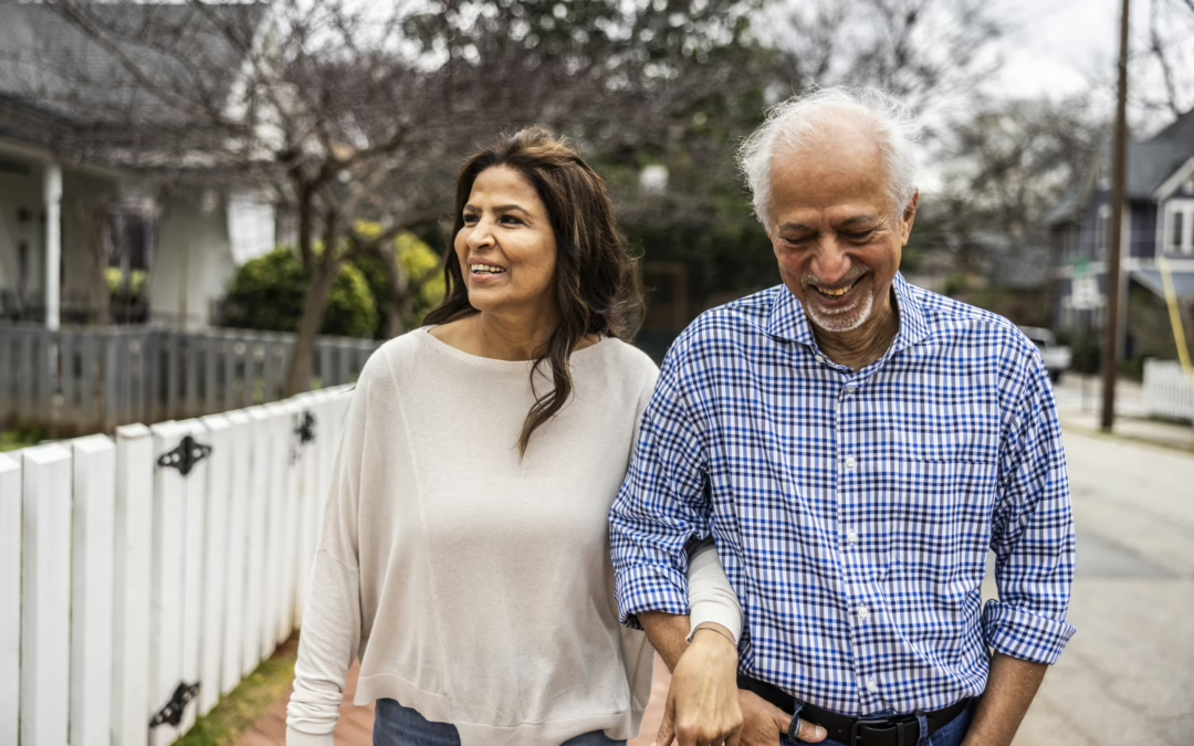 A couple walking in a neighborhood holding hands