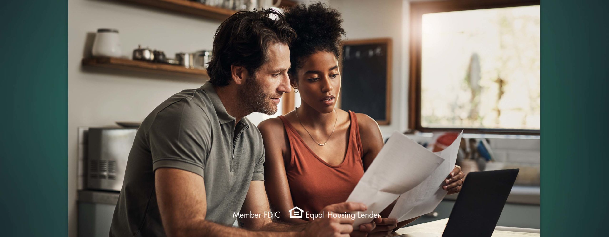 A couple reviewing paperwork together in their kitchen