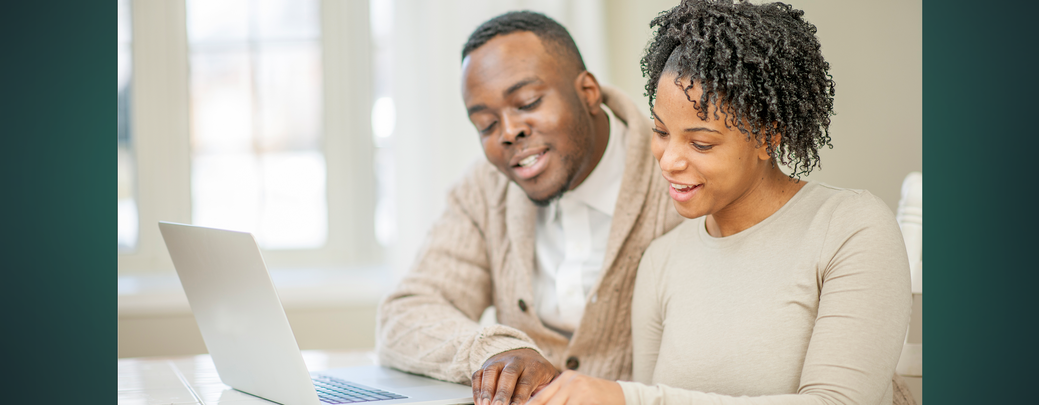 A couple reviewing their finances together on a laptop