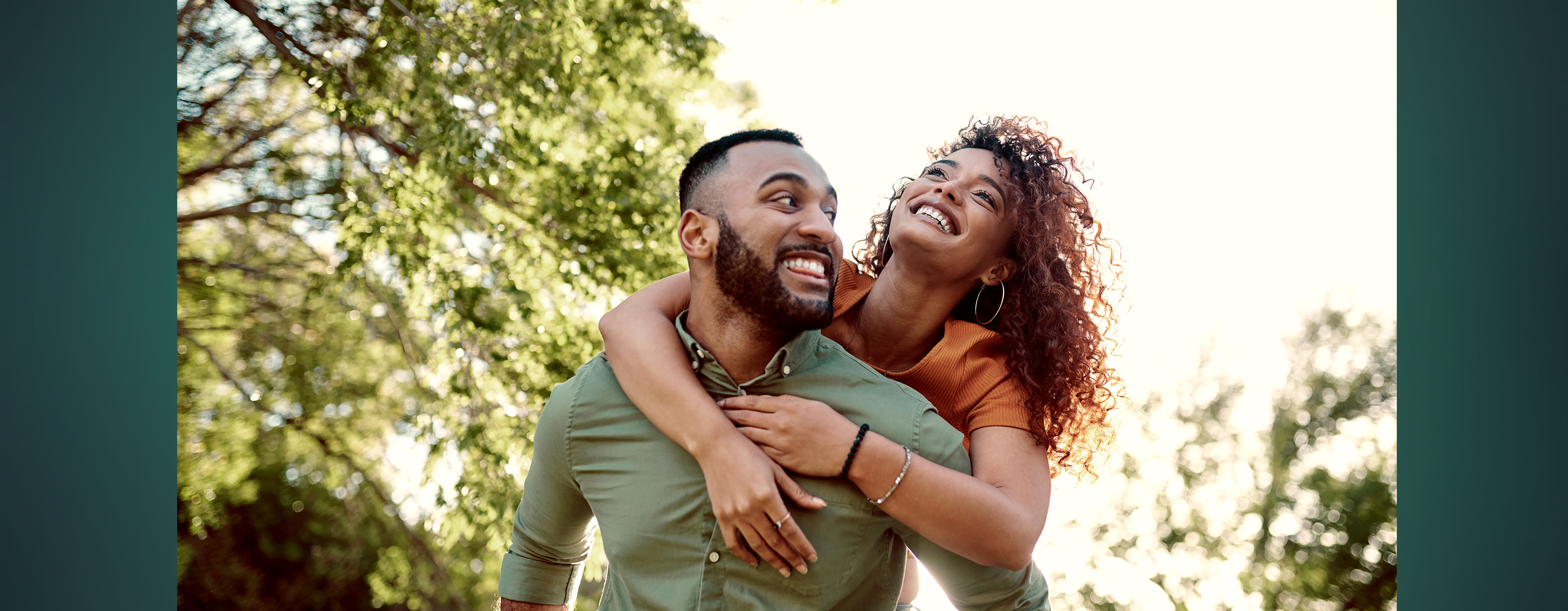 A smiling young couple enjoying a sunny day outside