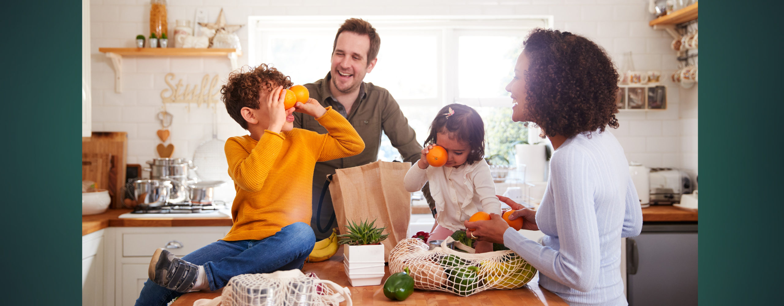A family unpacking groceries together in their kitchen