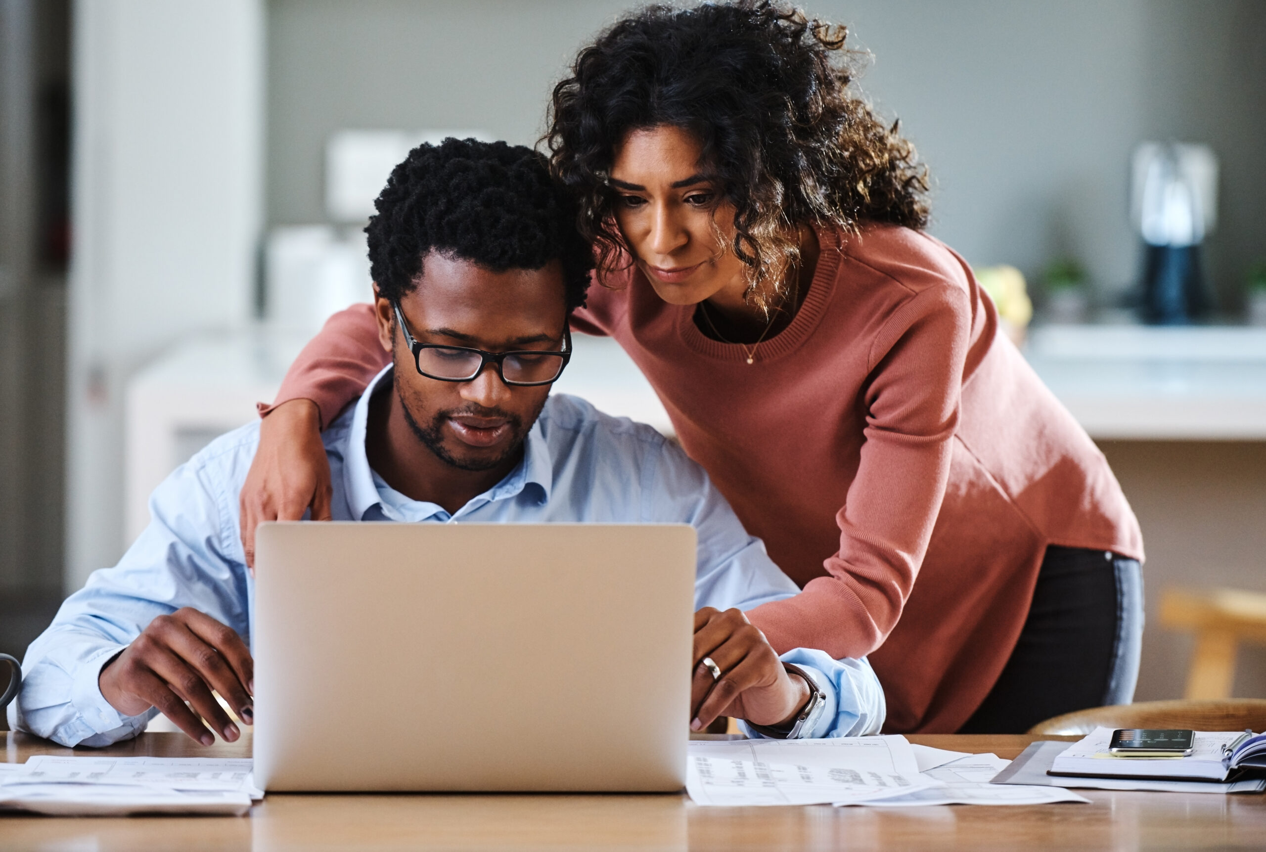 A couple looking at a laptop together
