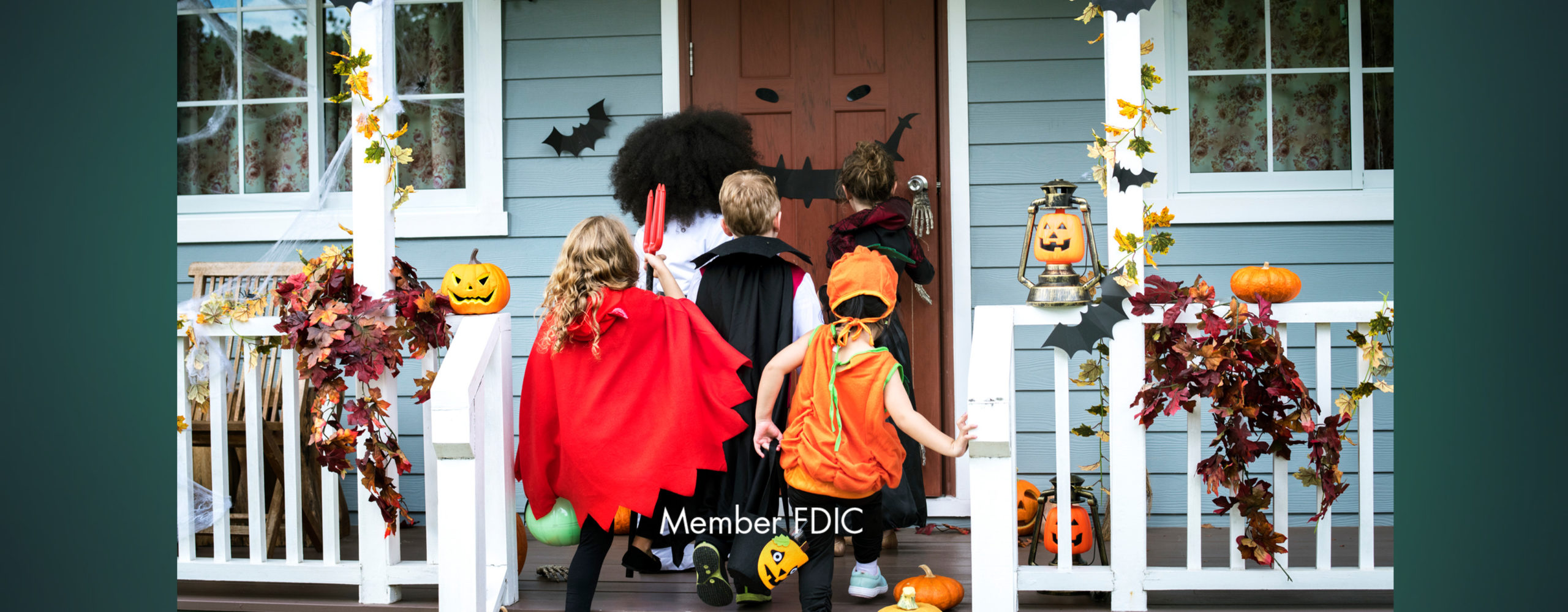 Five kids dressed in costumes walking up to a house to trick or treat