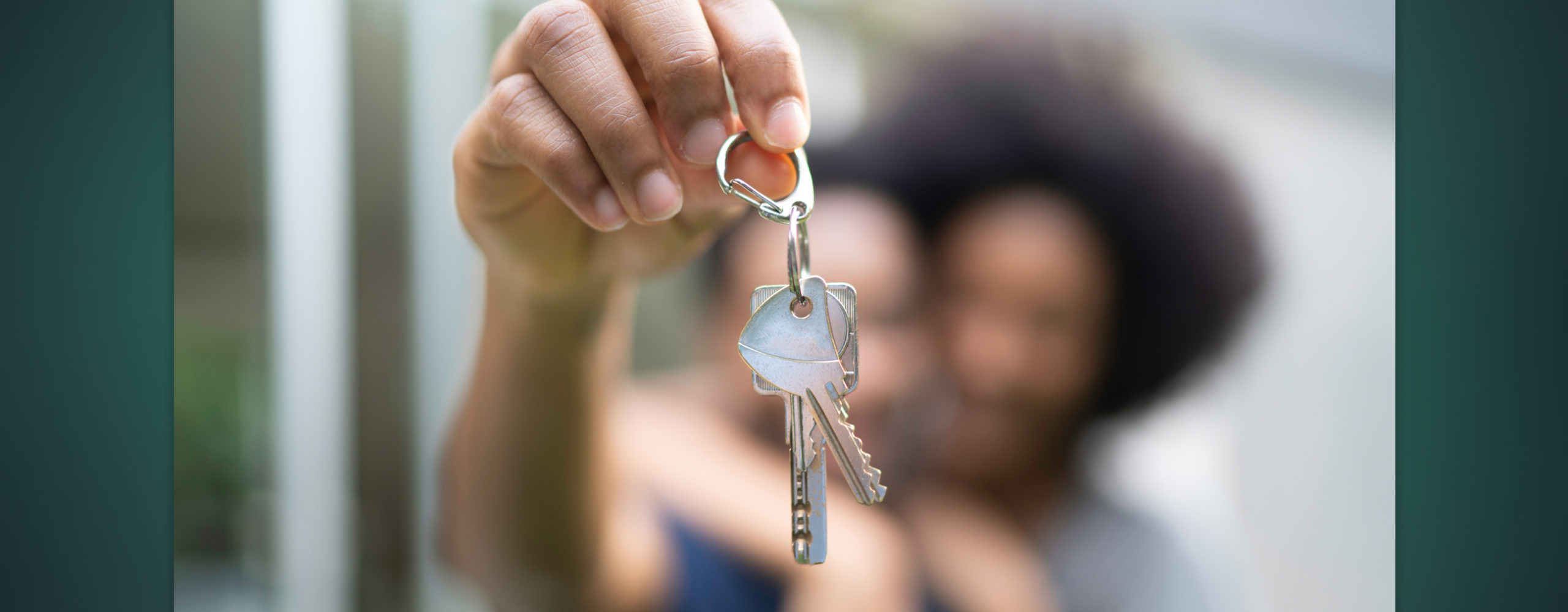 A close up of a hand holding house keys