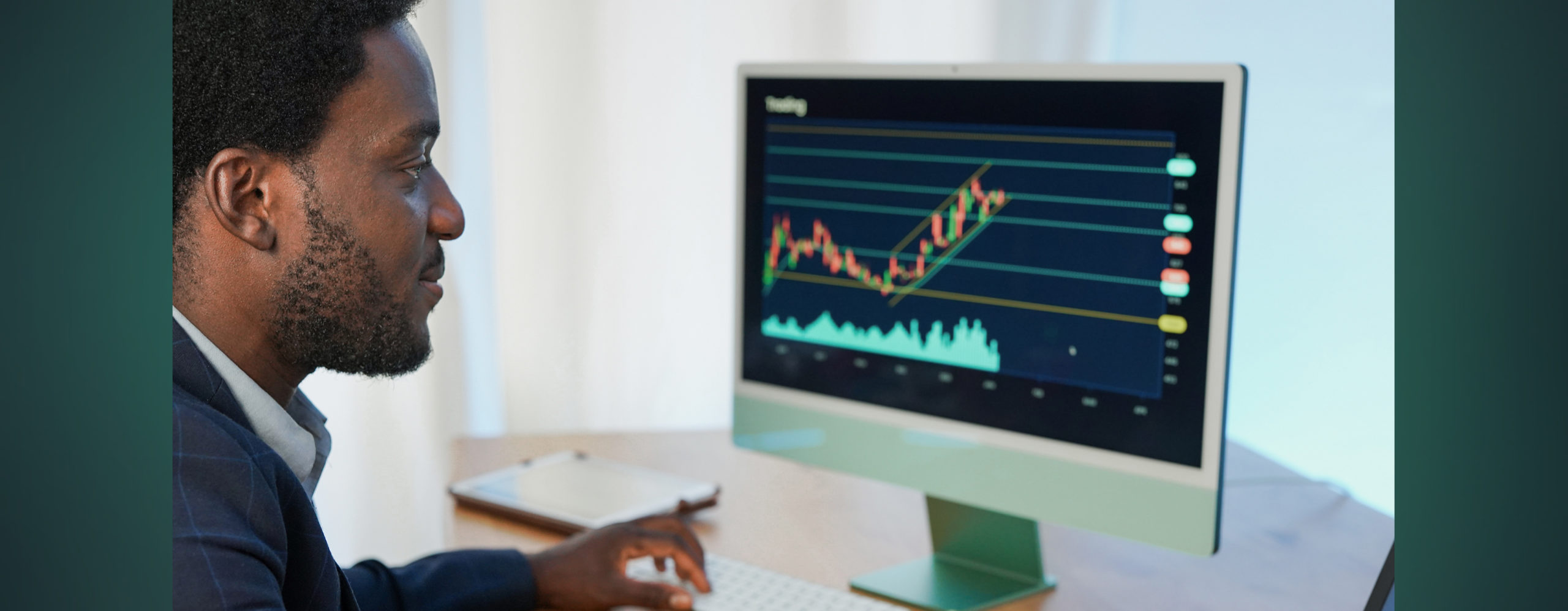 A man looking at an investment performance graph on a monitor