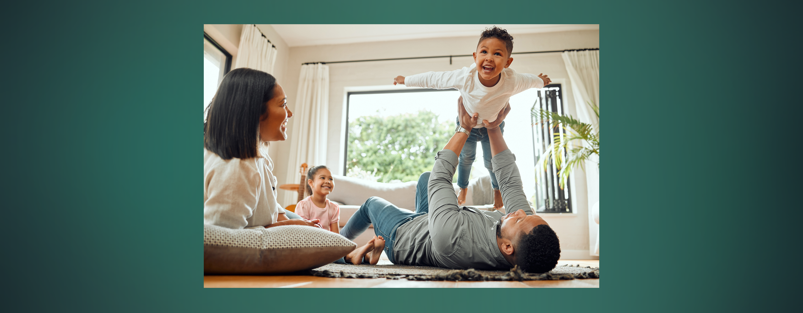 A family with two young kids playing together in their living room