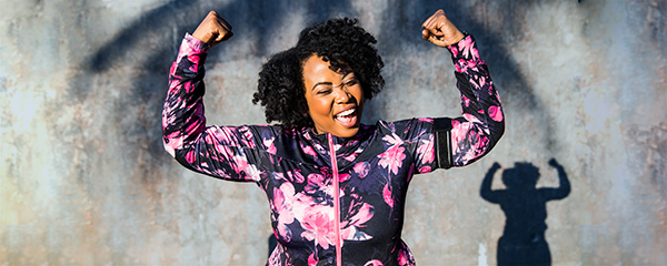 A woman celebrating after going on a run