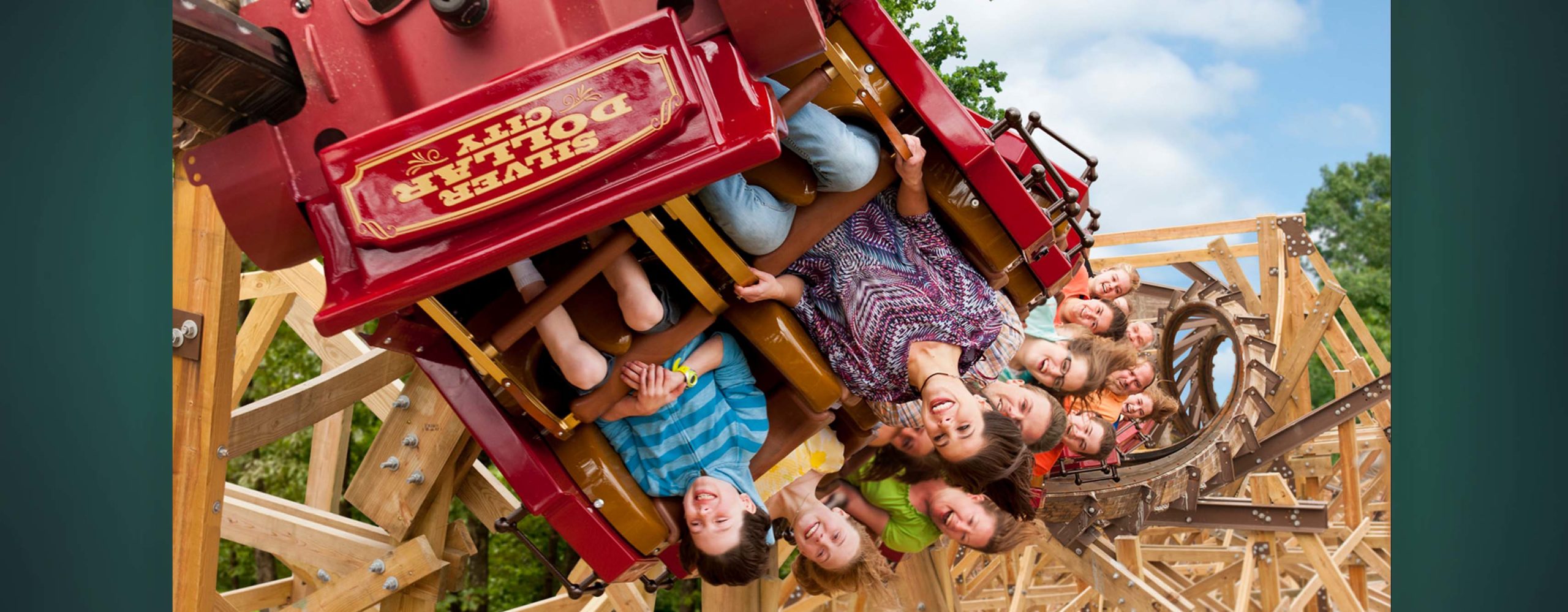 People smiling while riding a roller coaster at Silver Dollar City