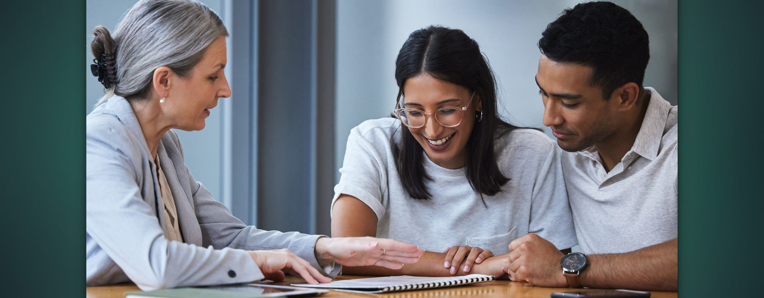 A couple reviewing a document with their financial advisor