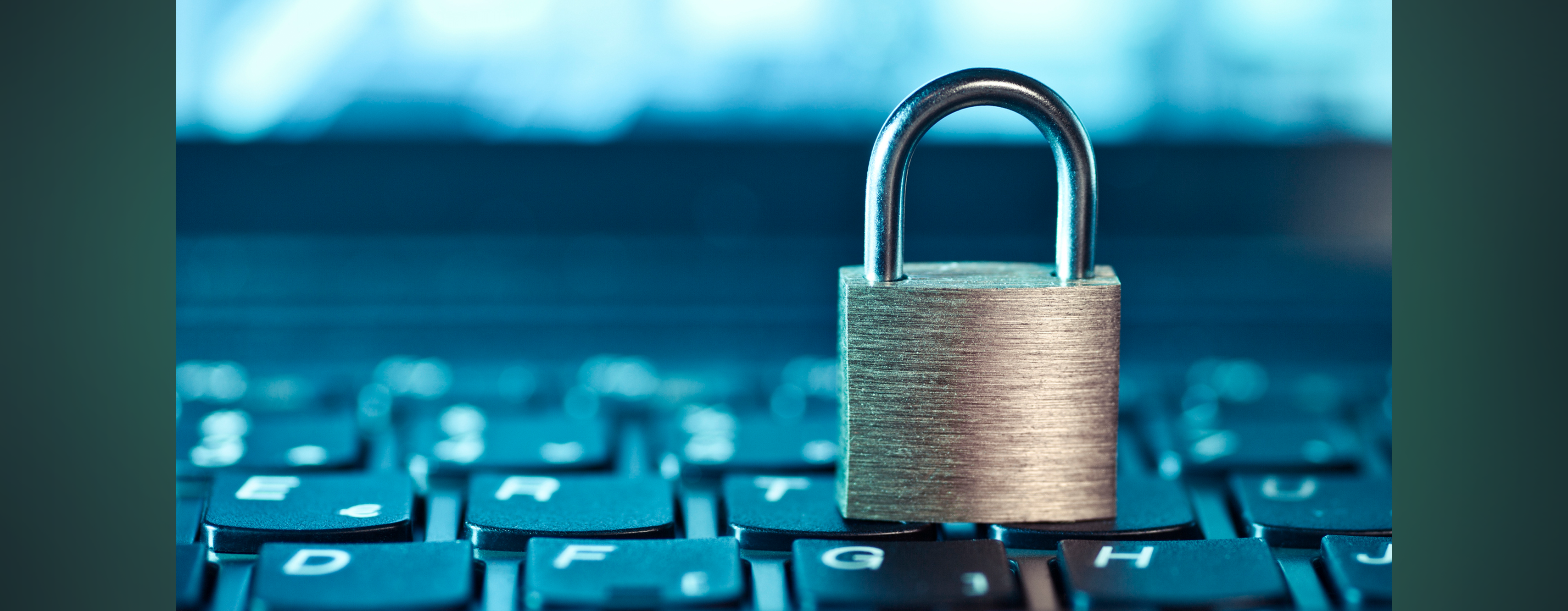 A pad lock sitting on top of a computer keyboard